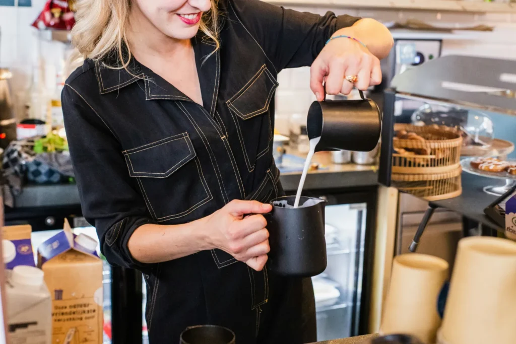 female barista making great coffee